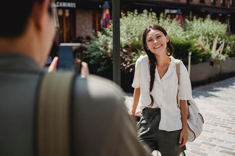 Young Asian woman smiling for a photo in a park