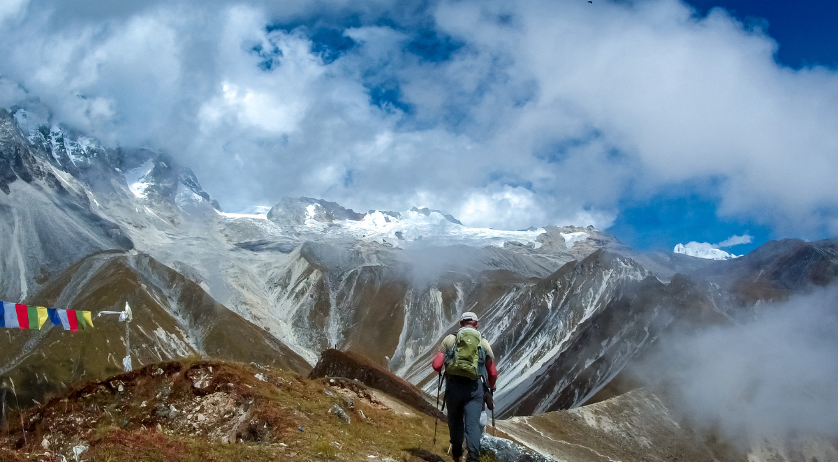 Caucasian male walking towards surreal Himalayan background in the Langtang region
