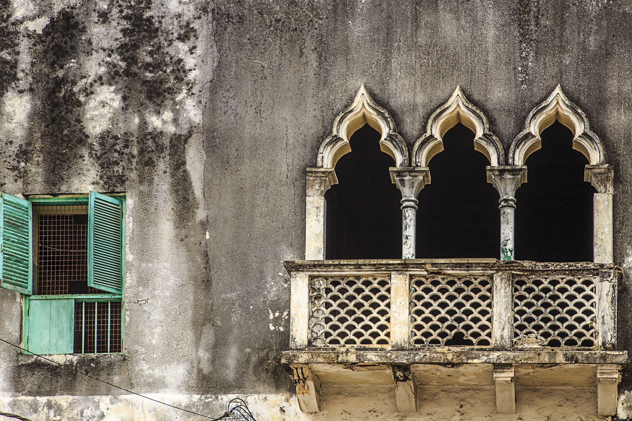 Arab-inspired pointed arches of windows in historic building of Stone Town, Zanzibar