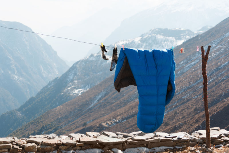 Airing cleaning washing sleeping bag on drying line in Everest