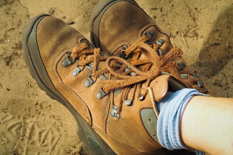 Close up of women's brown hiking boots and baby blue hiking socks