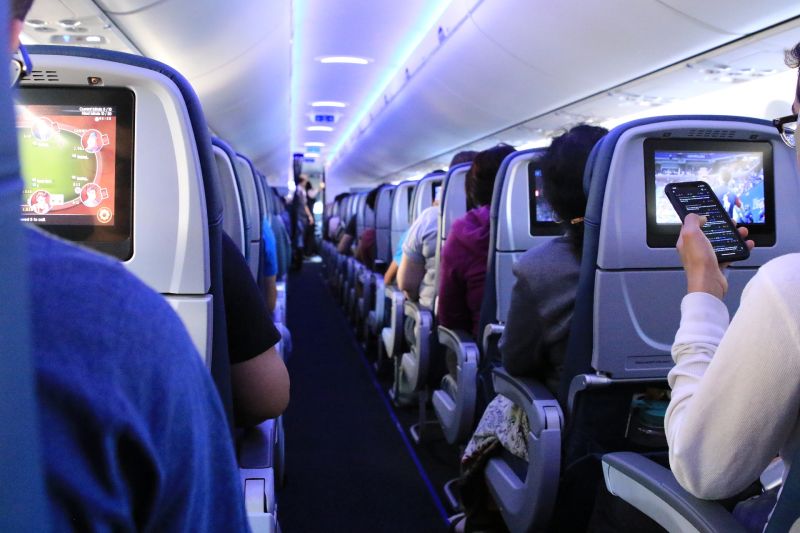 passengers seated in economy class on plane