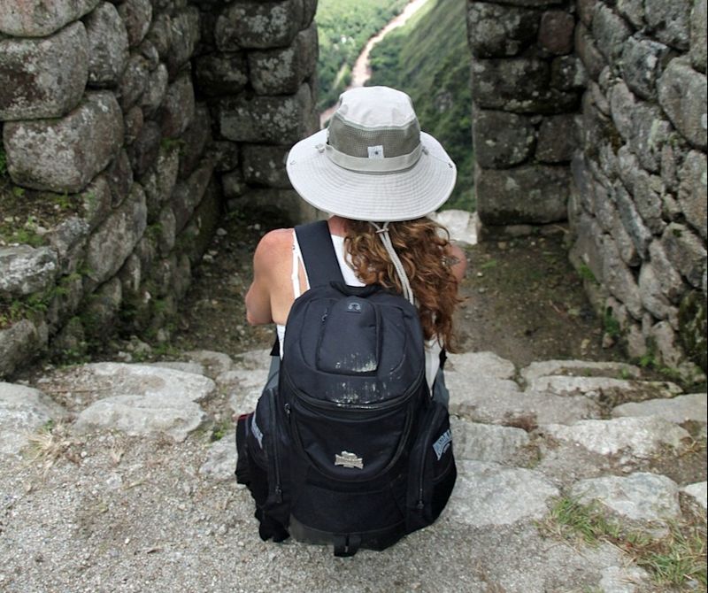 machu-picchu-girl-seated-in-ruins-peru