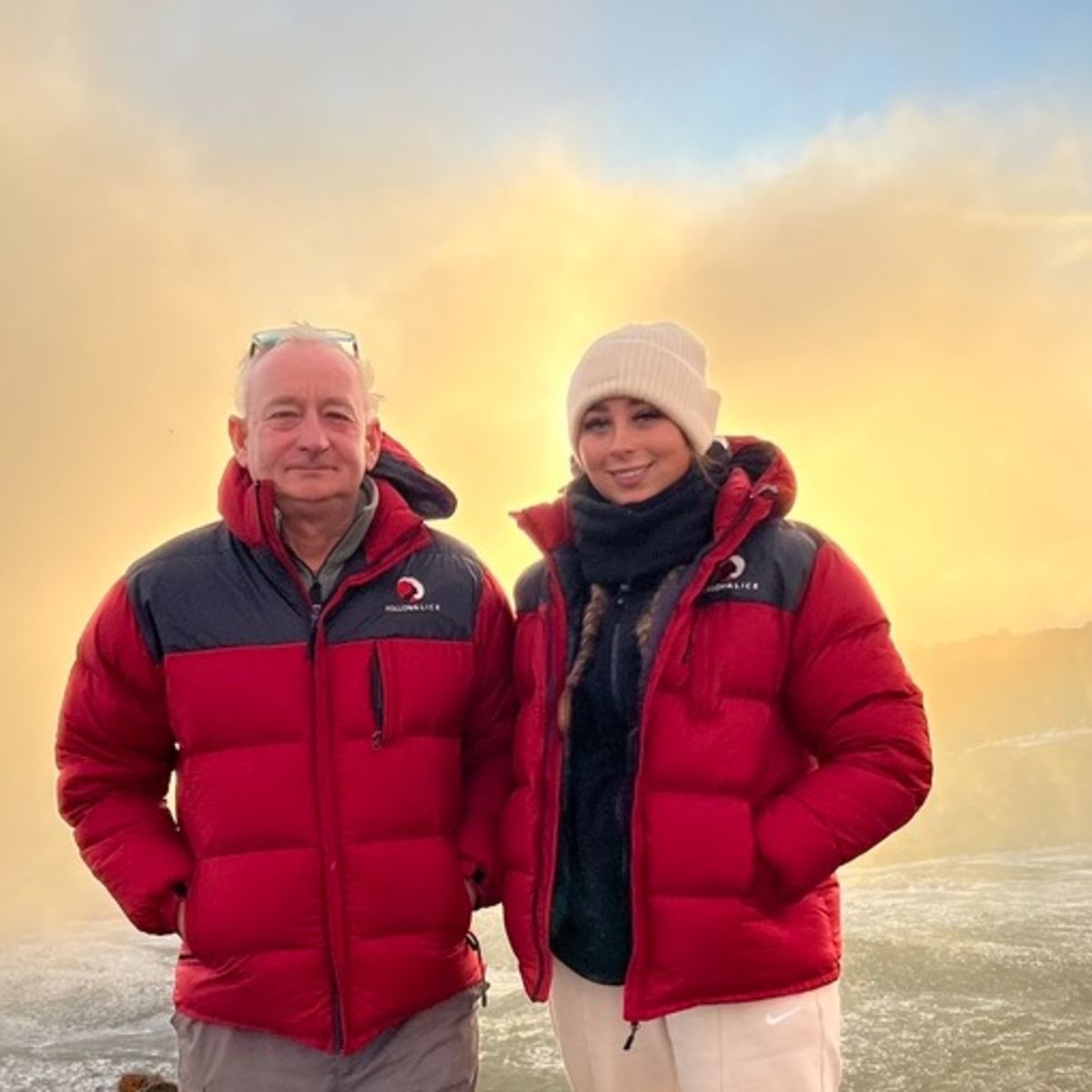Young woman and older man at Uhuru Peak on Kilimanjaro, different ages climbers in Follow Alice jackets