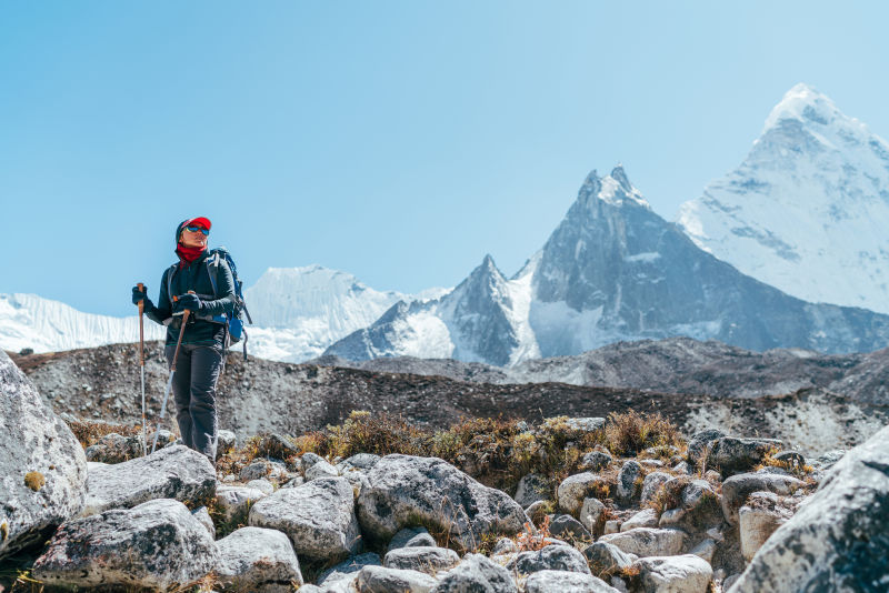 Female trekker on Everest Base Camp trek near Dingboche, Nepal. Ama Dablam 6,812 m in background