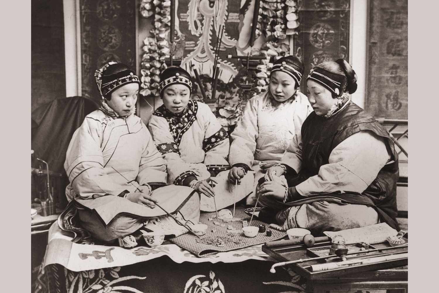 Chinese women playing a game together, about 1900.  Photo credit: Hulton Archive