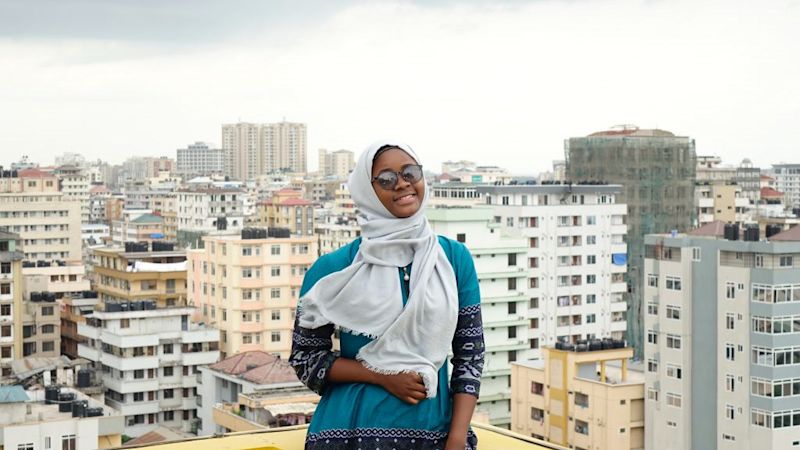 woman and view of Dar es Salaam