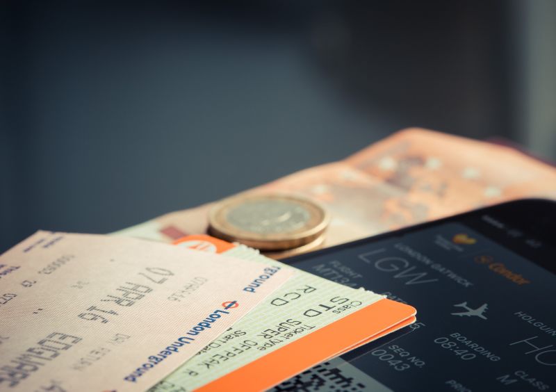 Airline tickets and pounds on a desk