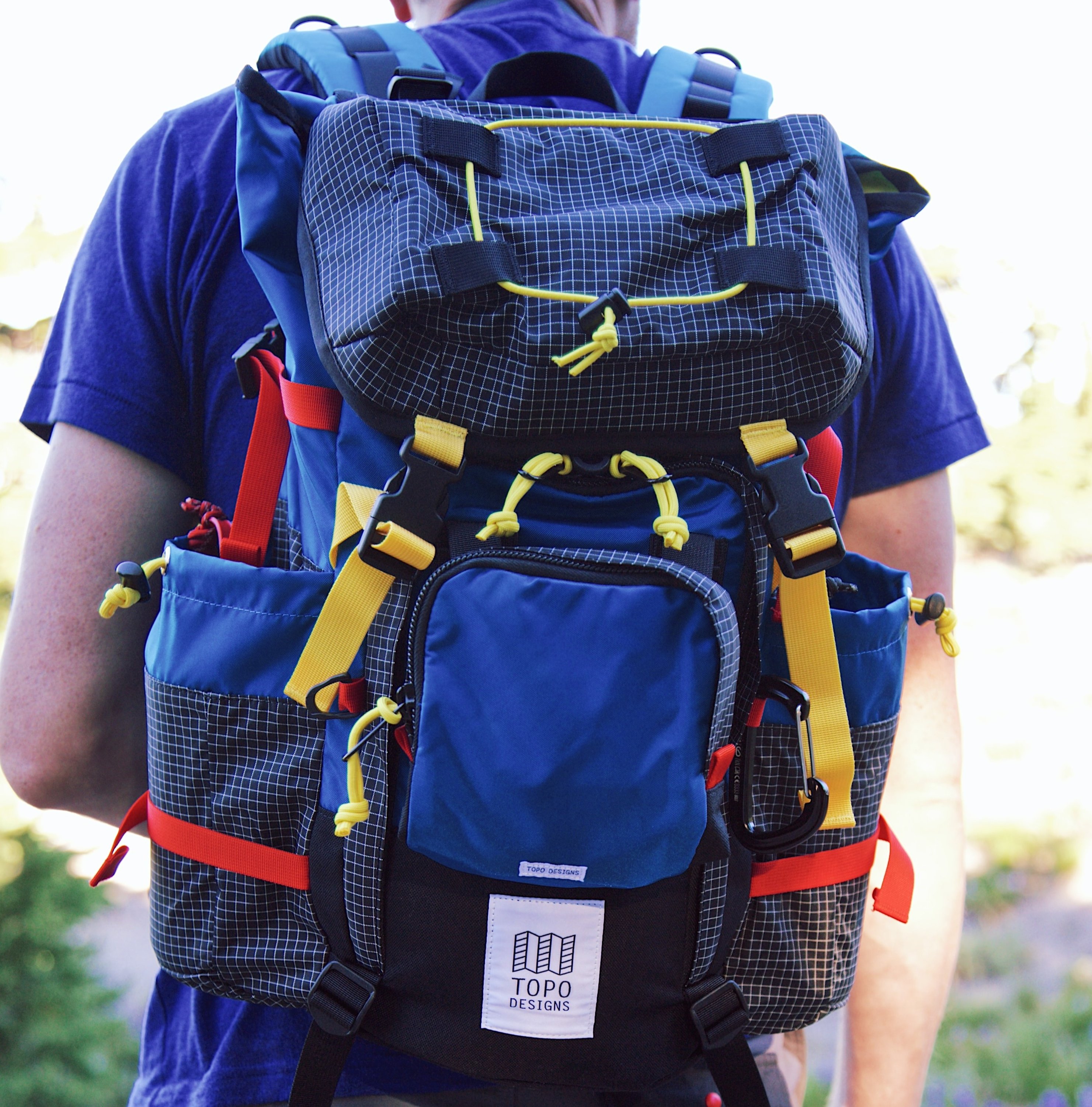 Multicoloured backpack with lots of straps and pockets
