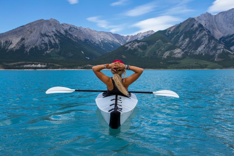 Blonde woman paddling on lake