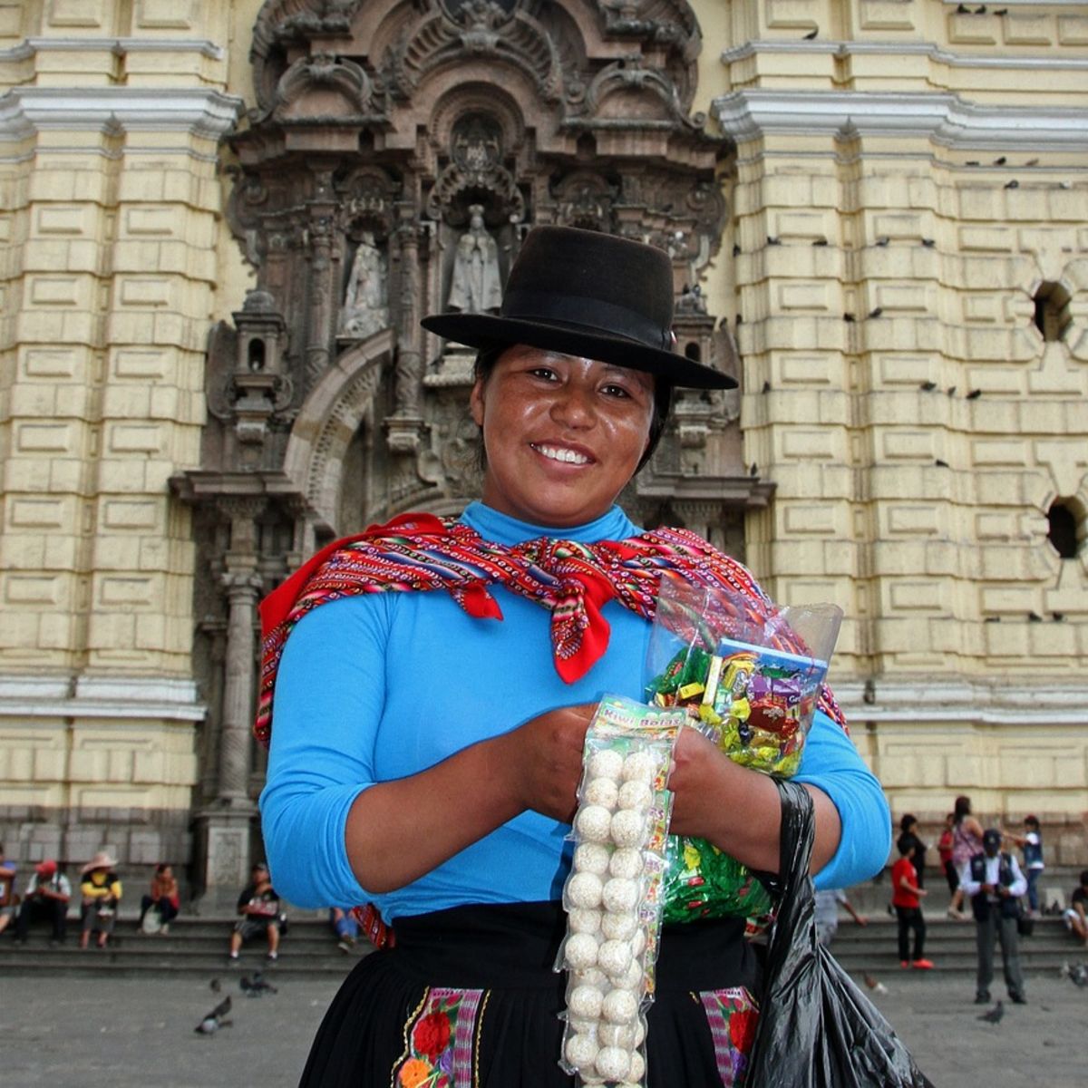 Smiling local woman selling sweets in Lima, Peru