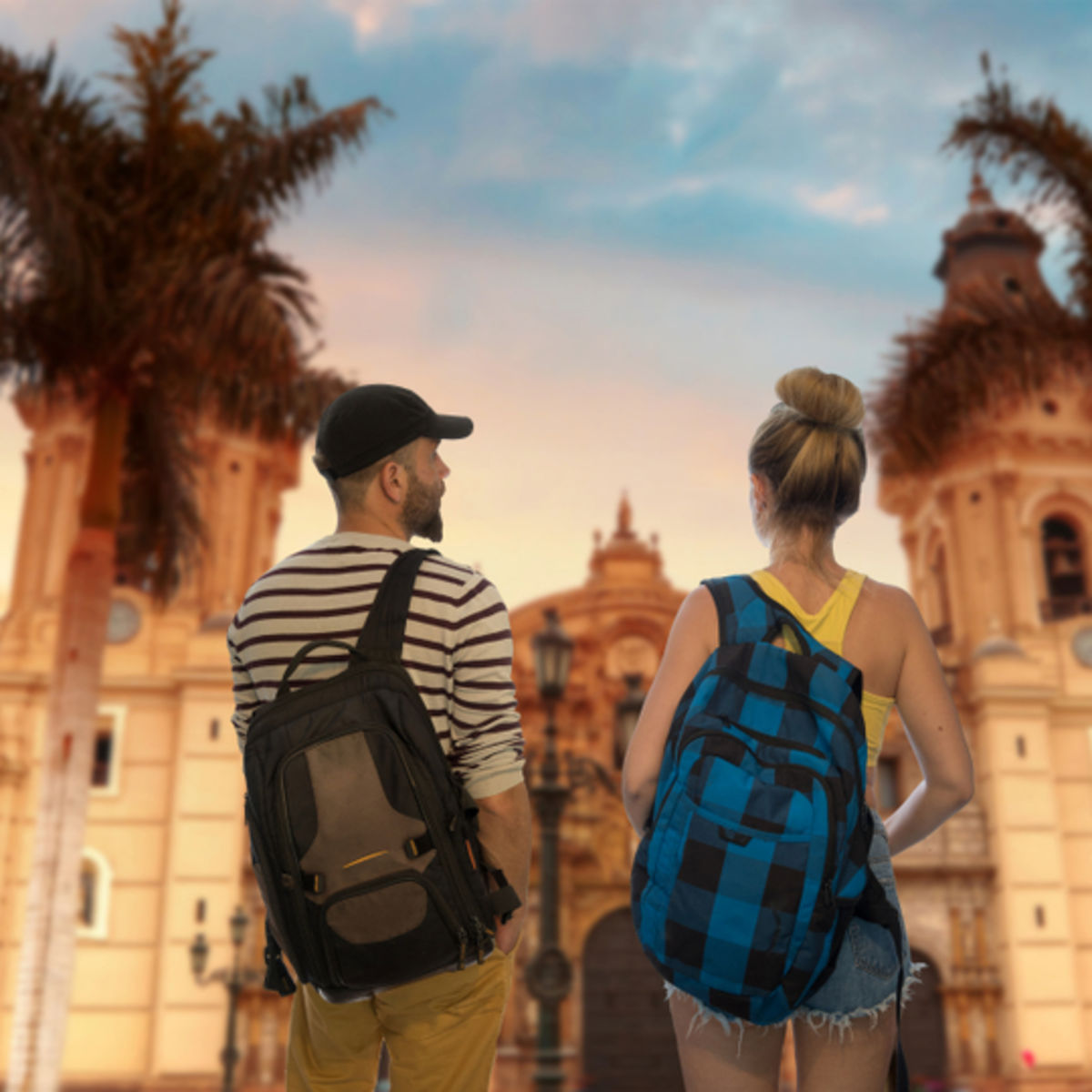 Young couple at sunset in Lima main square, Peru. Colonial building and pam trees