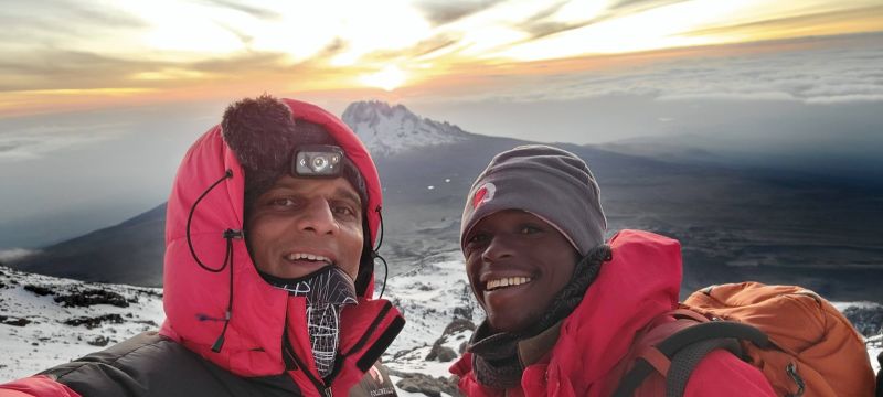 Rafiq and Trevor, Chris's son, summit of Kilimanjaro