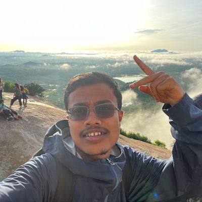 Man looking at camera with clouds behind him