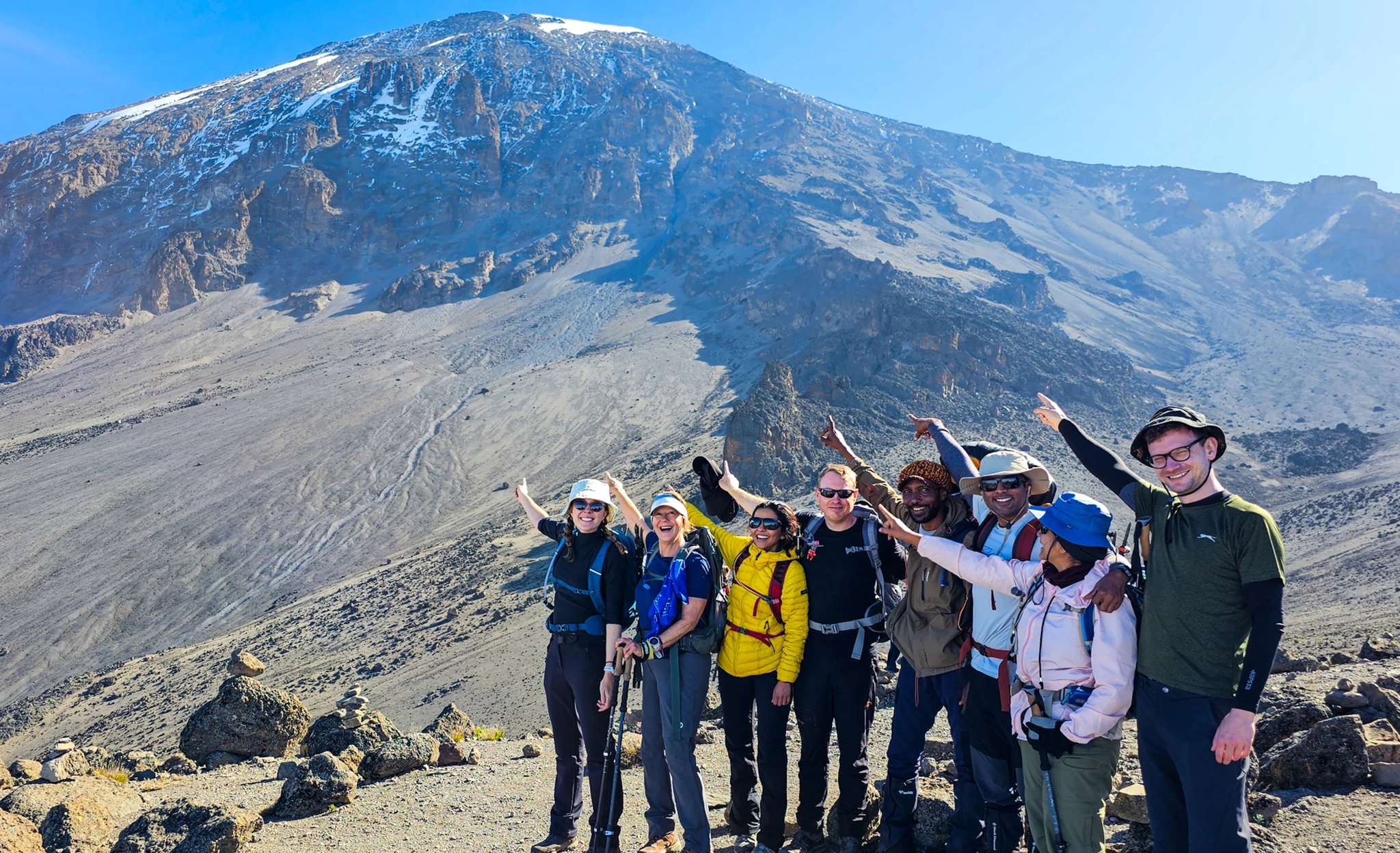 Mount Kilimanjaro trekkers pointing to Mount Kilimanjaro