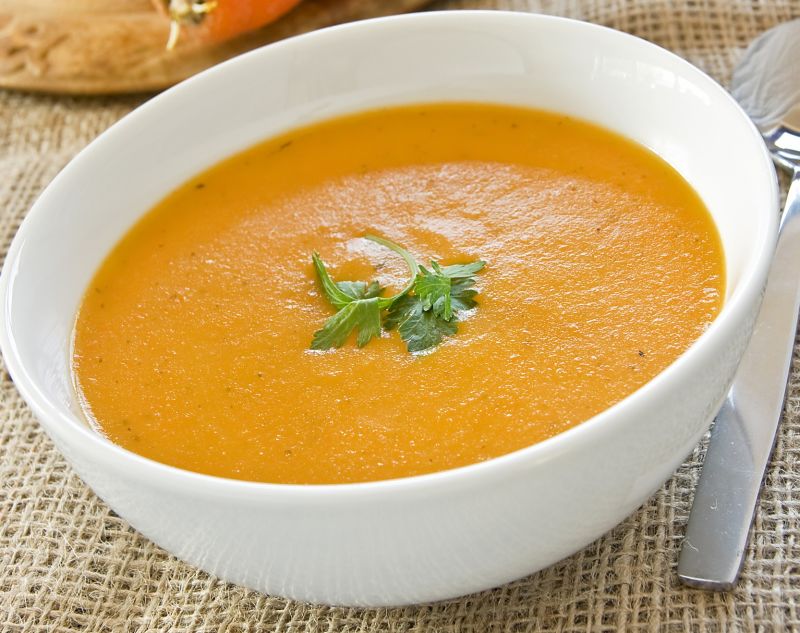 Carrot and coriander soup in a white bowl