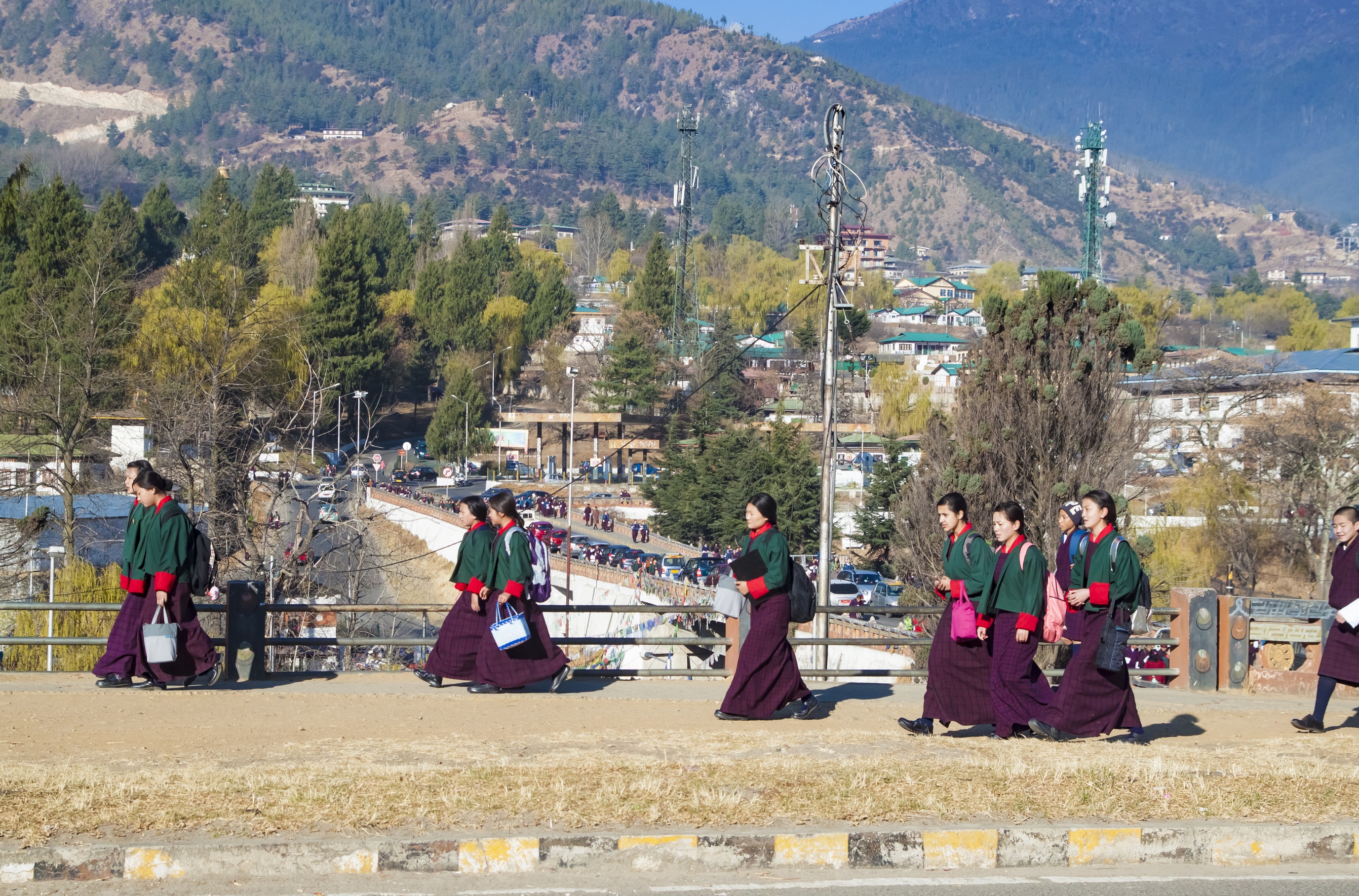 Young Bhutanese girls in uniform traditional women dress named kira, wonju long-sleeved blouse and a short jacket toego go to school classes, in early morning