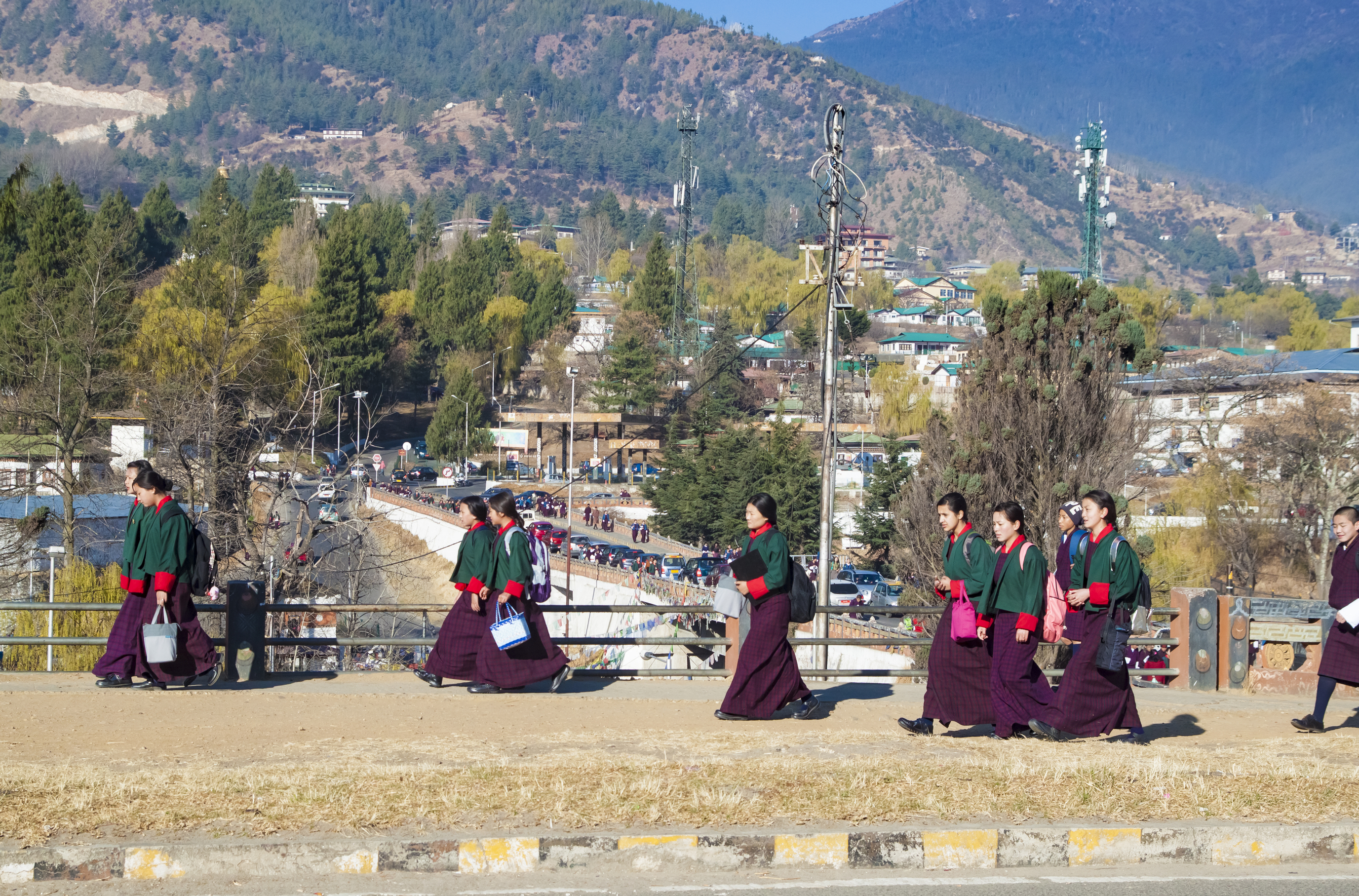 Young Bhutanese girls in uniform traditional women dress named kira, wonju long-sleeved blouse and a short jacket toego go to school classes, in early morning