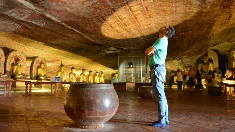 Admire centuries old paintings in the Dambulla Rock Caves