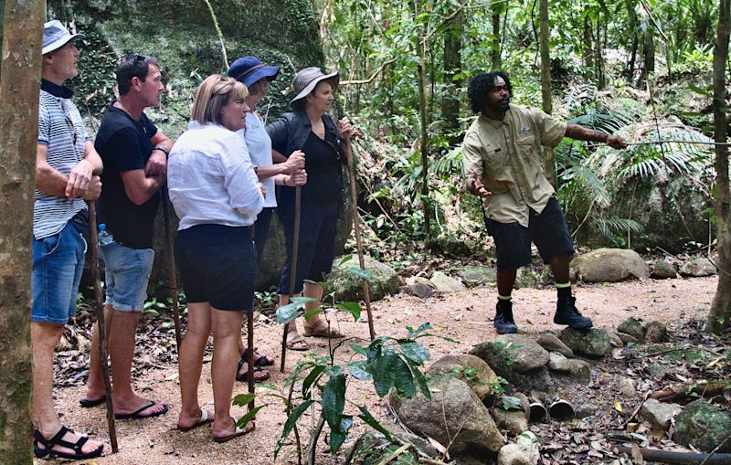 Tour guide and group in bush walk nature