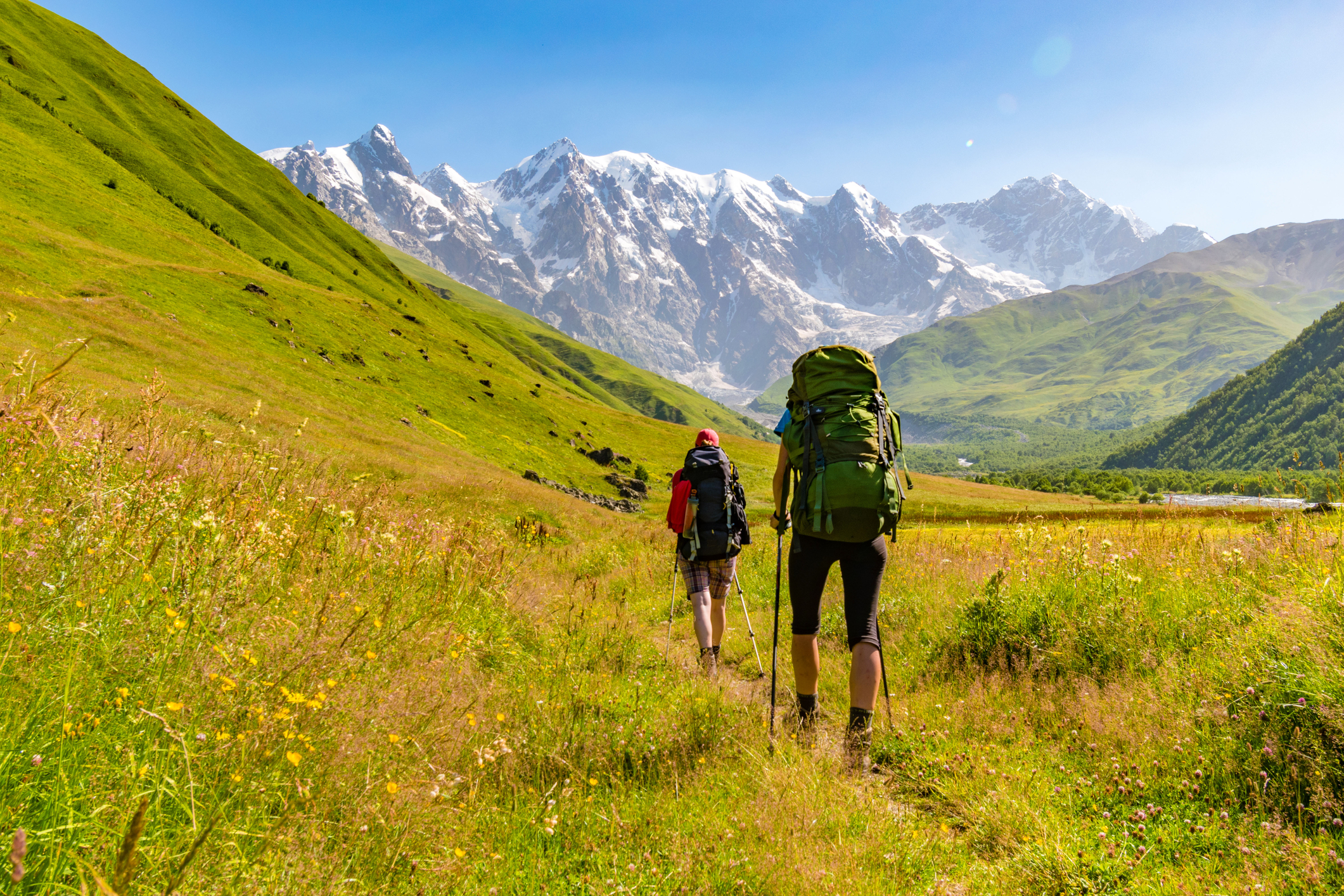 Young active girls hiking in Greater Caucasus mountains, Mestia district, Svaneti region, Georgia