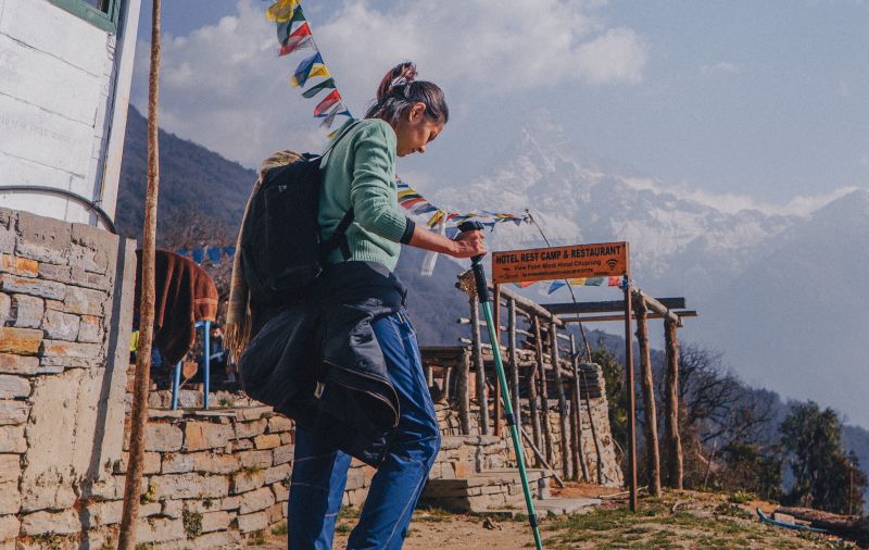 trekking poles woman Nepal prayer flags