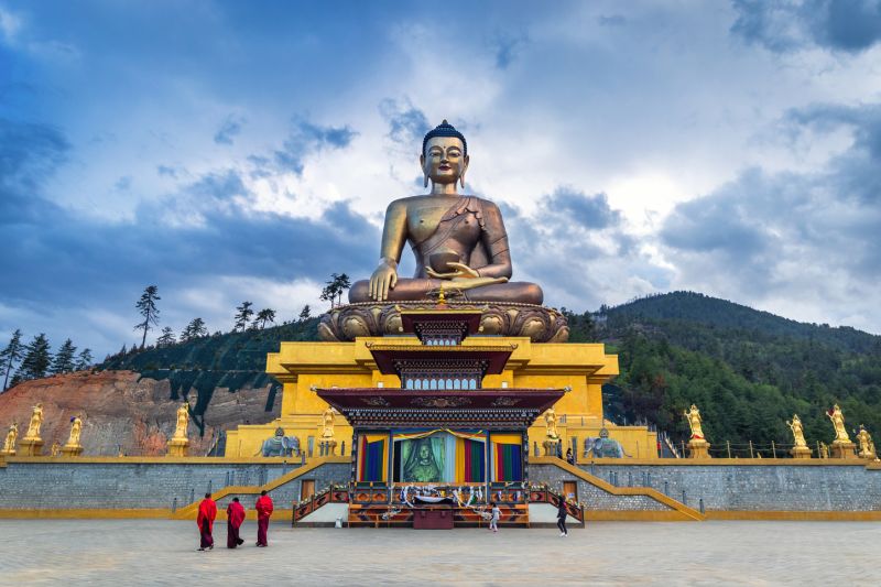 Buddha Dordenma statue with monks and tourists in Thimphu, Bhutan