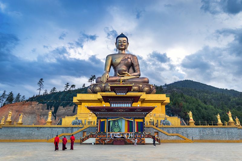 Buddha Dordenma statue with monks and tourists in Thimphu, Bhutan