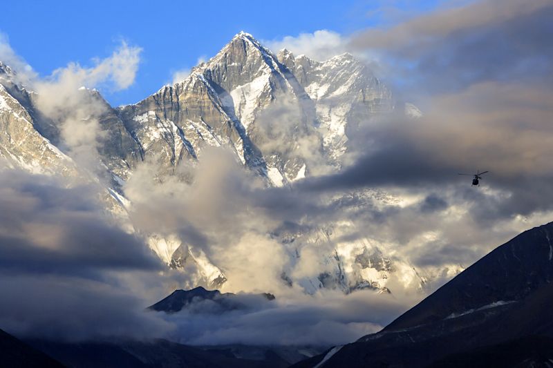 Pur. Helicopter flies past Lhotse mountain, Everest Base Camp trek, Nepal