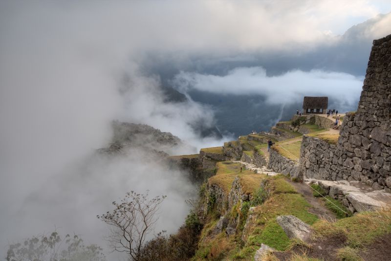 Clouds and mist surrounding Machu Picchu ruins, Peru 