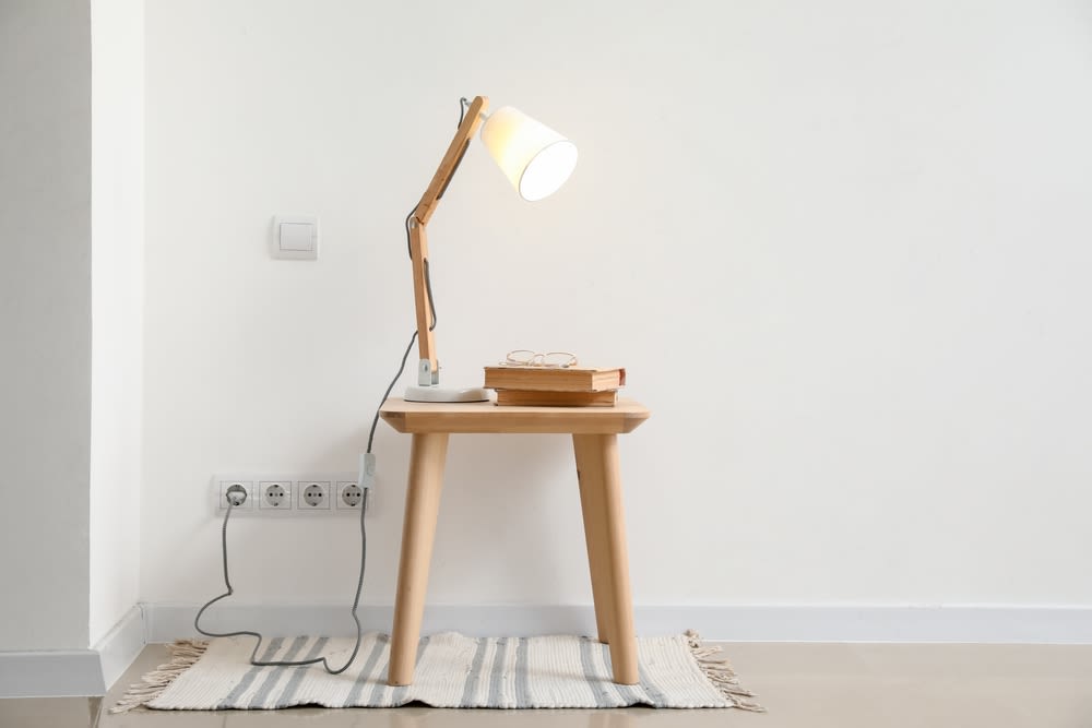 Lamp on side table and plugged into wall
