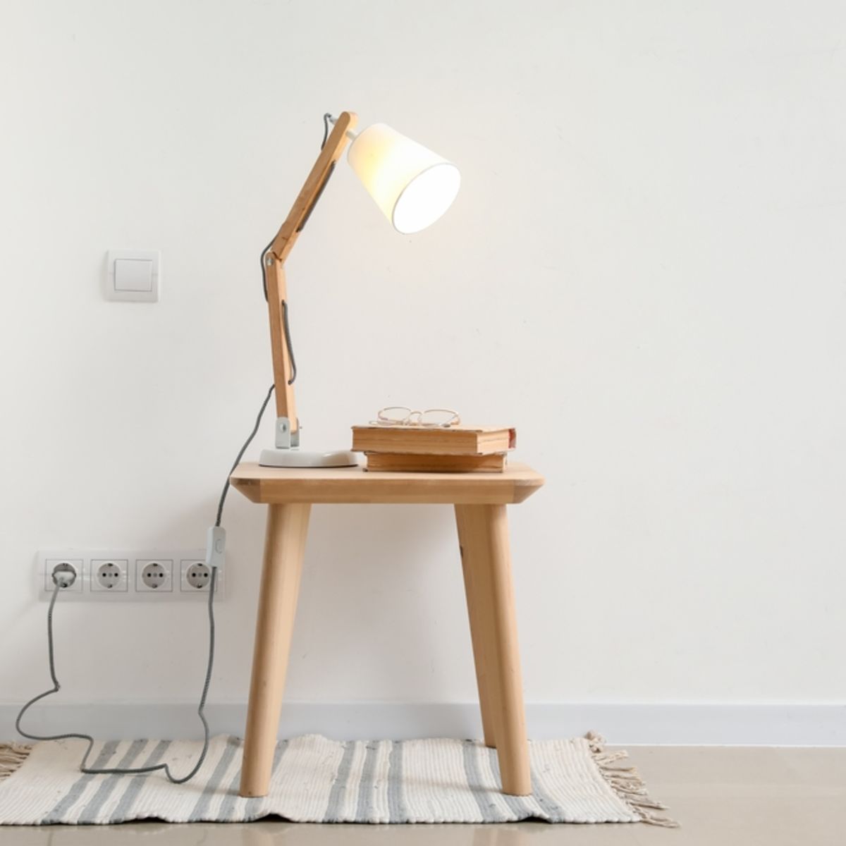 Lamp on side table and plugged into wall
