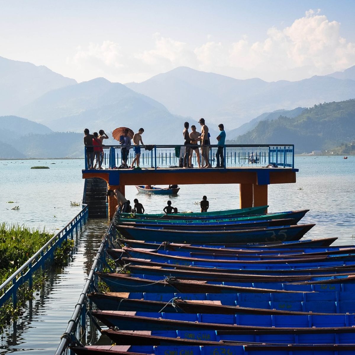 Jetty and canoes on Lake Phewa, Pokhara, Annapurna Mountains, Nepal