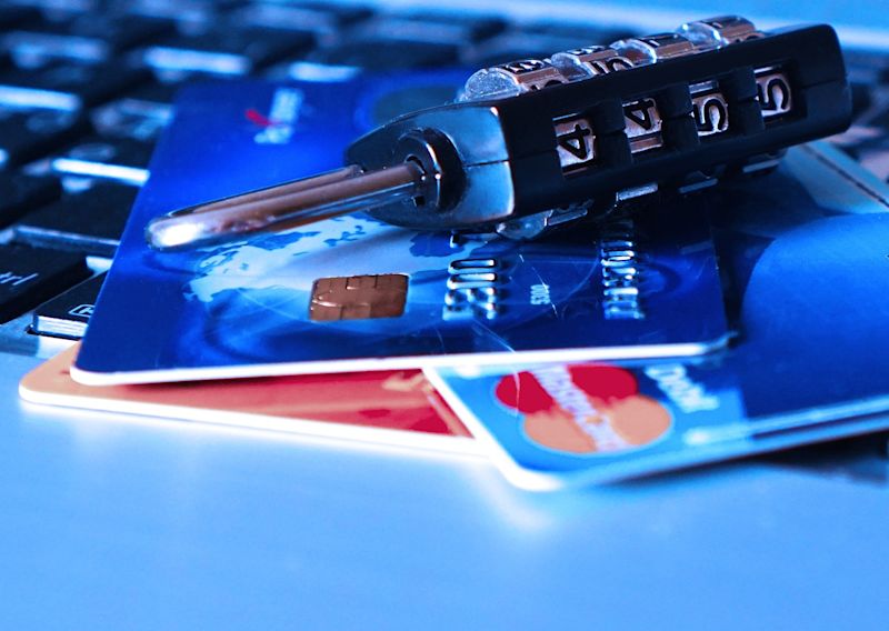 Close up of padlock and bank cards on keyboard