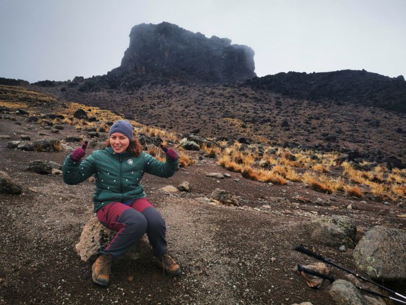 Arwa sitting on a rock on Kilimanjaro