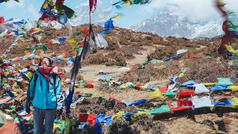 Nepal lady prayer flags Between pangboche and Pheriche way to Everest BC