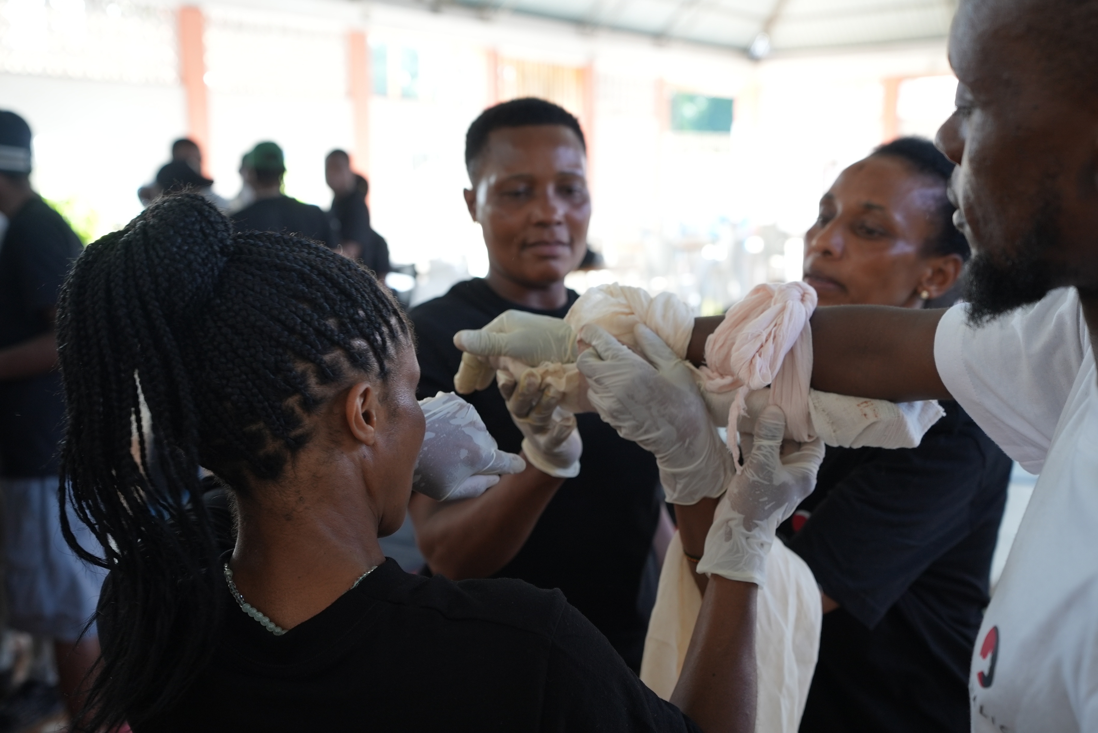 First aid course practising arm bandage