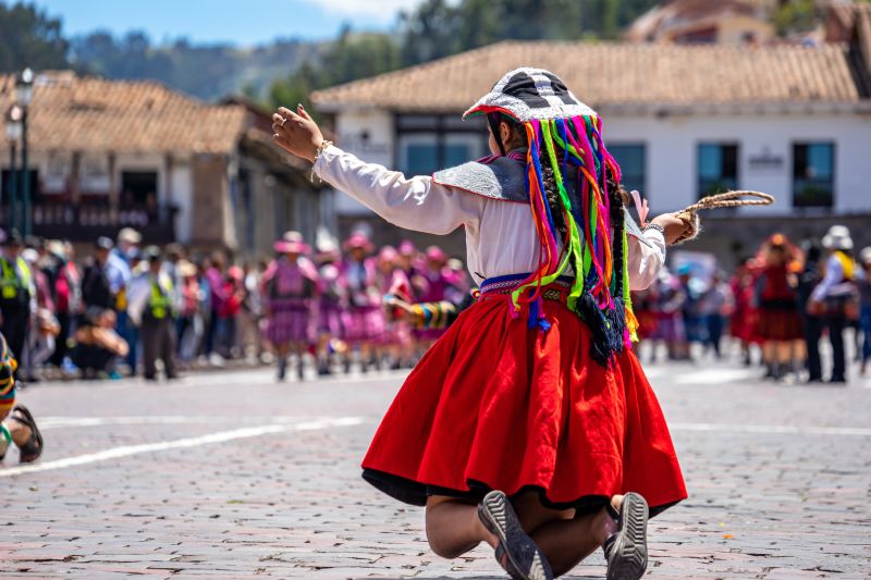 Peru, Cusco, traditional dances for the Easter Parade on the Plaza de Armas. Dancer wear colourful costumes and head covers 
