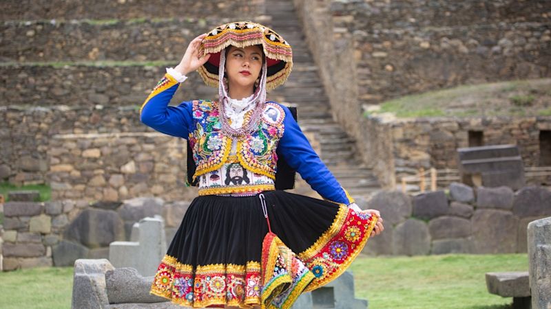 Beautiful girl with traditional dress from Peruvian Andes culture. Young girl in Ollantaytambo city in Incas Sacred Valley in Cusco Peru
