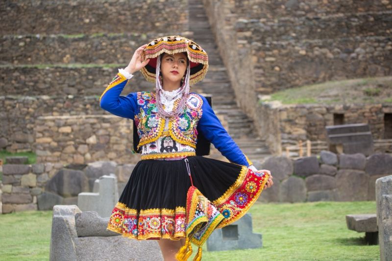 Beautiful girl with traditional dress from Peruvian Andes culture. Young girl in Ollantaytambo city in Incas Sacred Valley in Cusco Peru