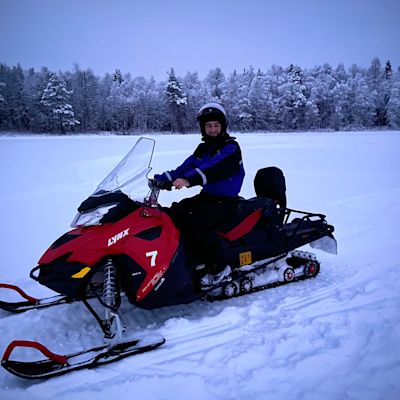 Man on snow mobile in snowy landscape