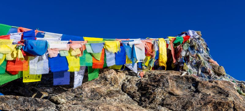 Colorful prayer flags on Gokyo Ri mountain summit in Nepal