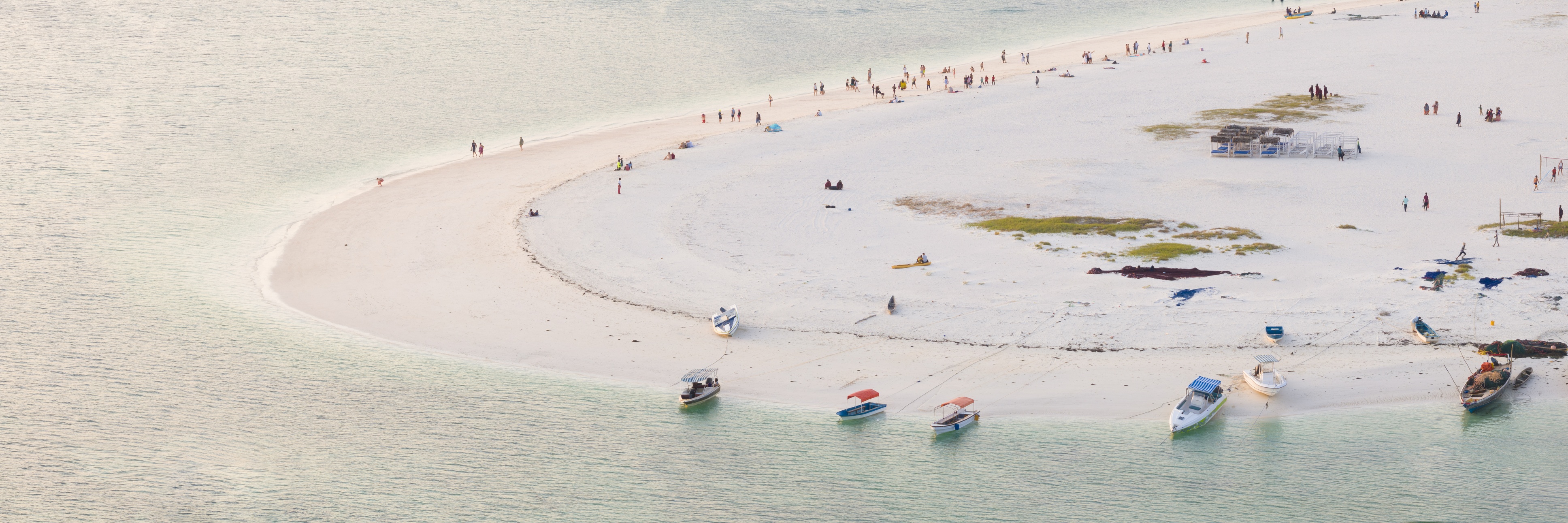 Zanzibar coastline seen from above with boats and dhows and people on beach
