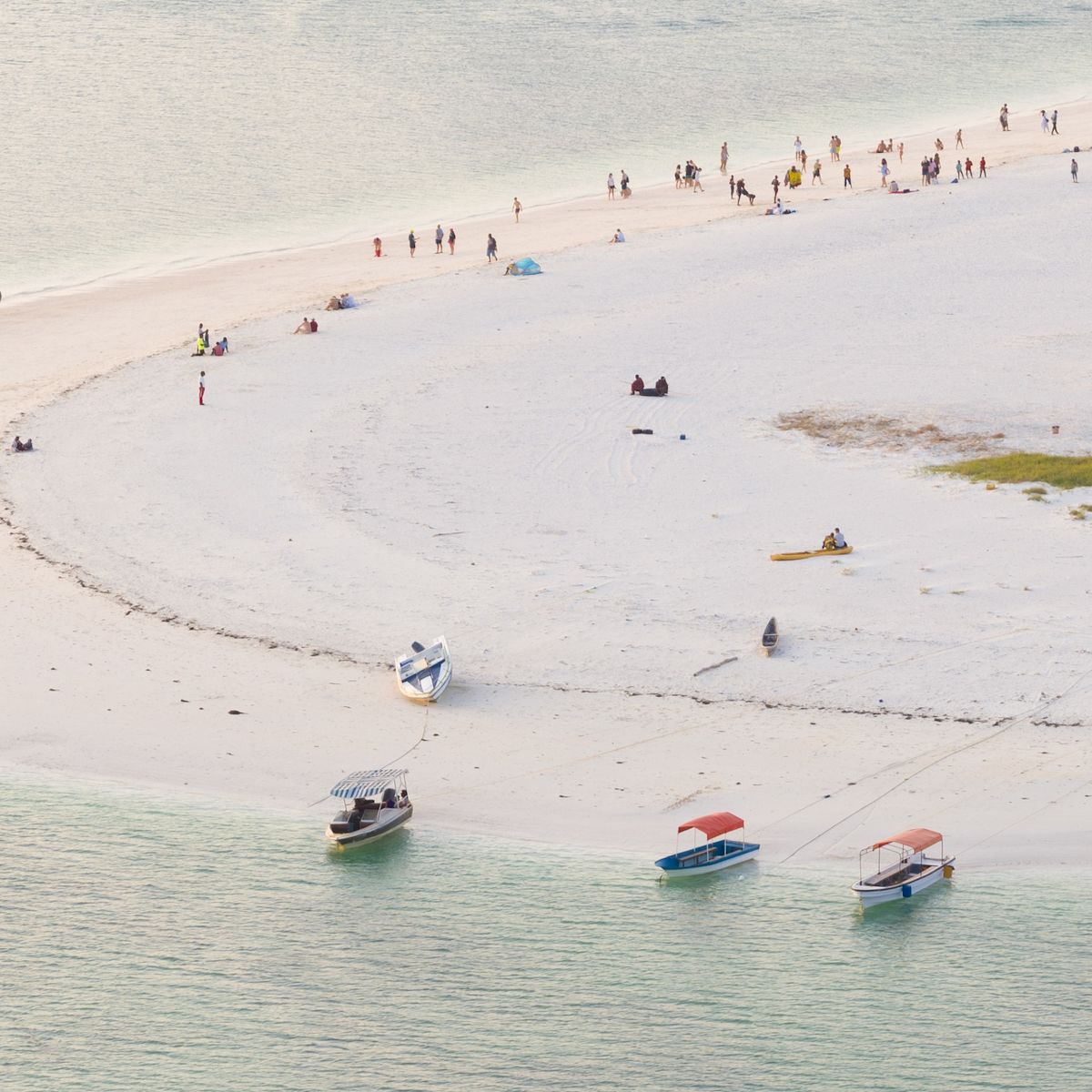 Zanzibar coastline seen from above with boats and dhows and people on beach