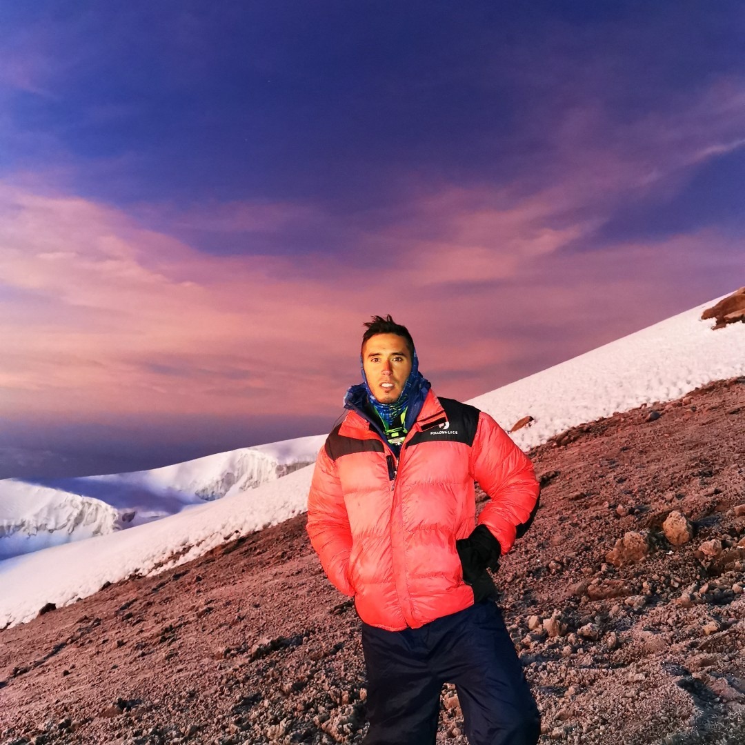 Smiling client on Mount Kilimanjaro at sunrise