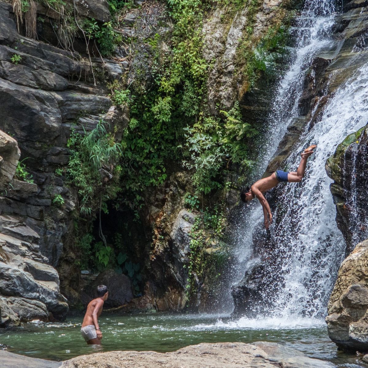 Boys jumping into waterfall in Sri Lanka
