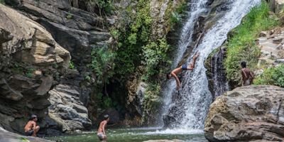 Boys jumping into waterfall in Sri Lanka