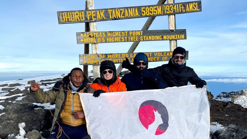 Kilimanjaro summit Uhuru FA flag group photo George K.