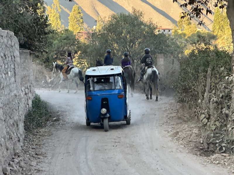 Horse riders on dirt road in Urubamba, Sacred Valley, Cusco