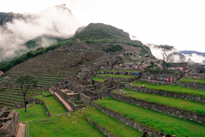 Crowds of visitors and trekkers exploring Machu Picchu in Peru